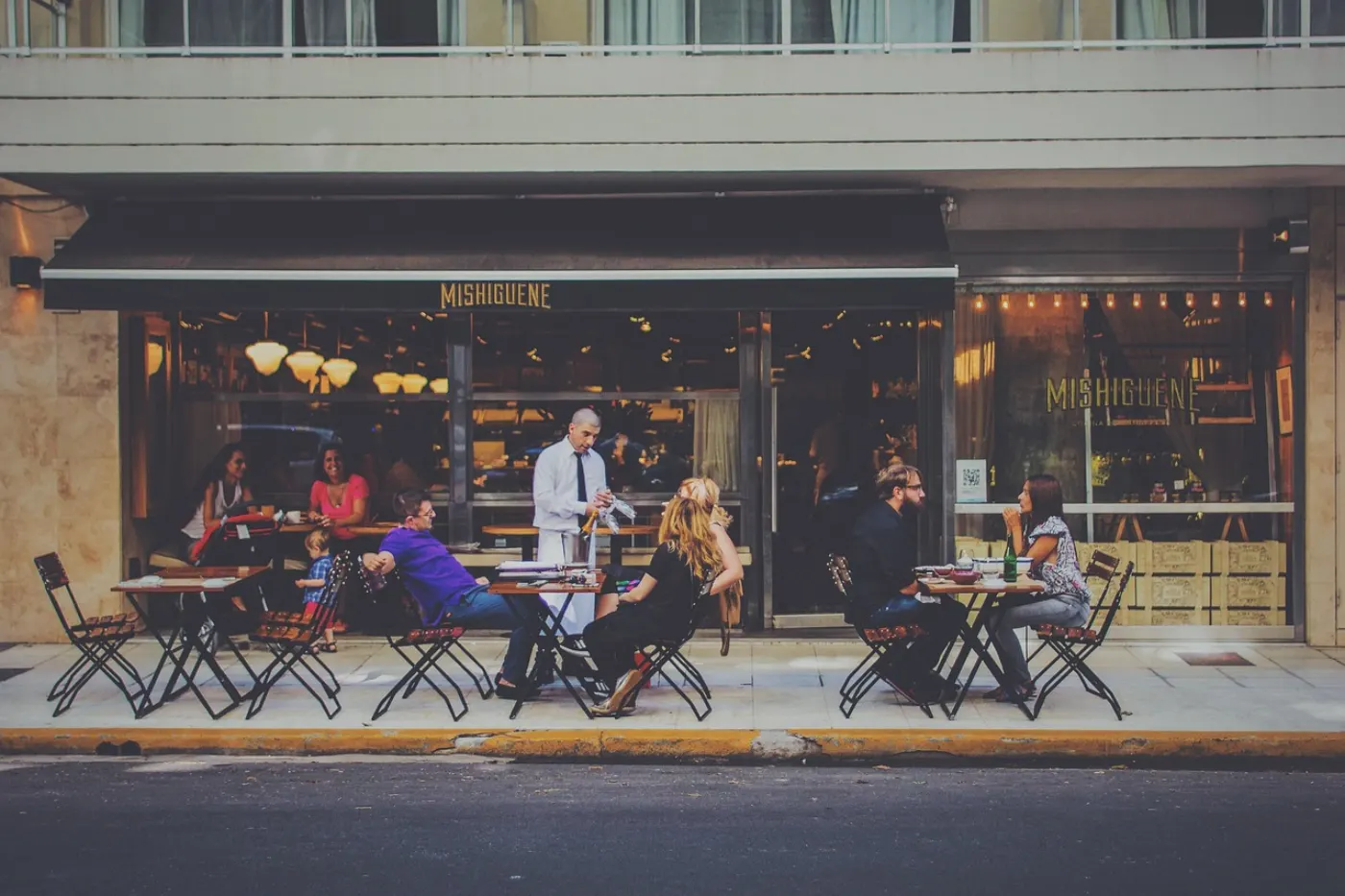 Restaurant patio with multiple tables during evening service